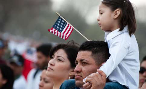 A girl and her father stand with some 200,000 immigrant rights activists.